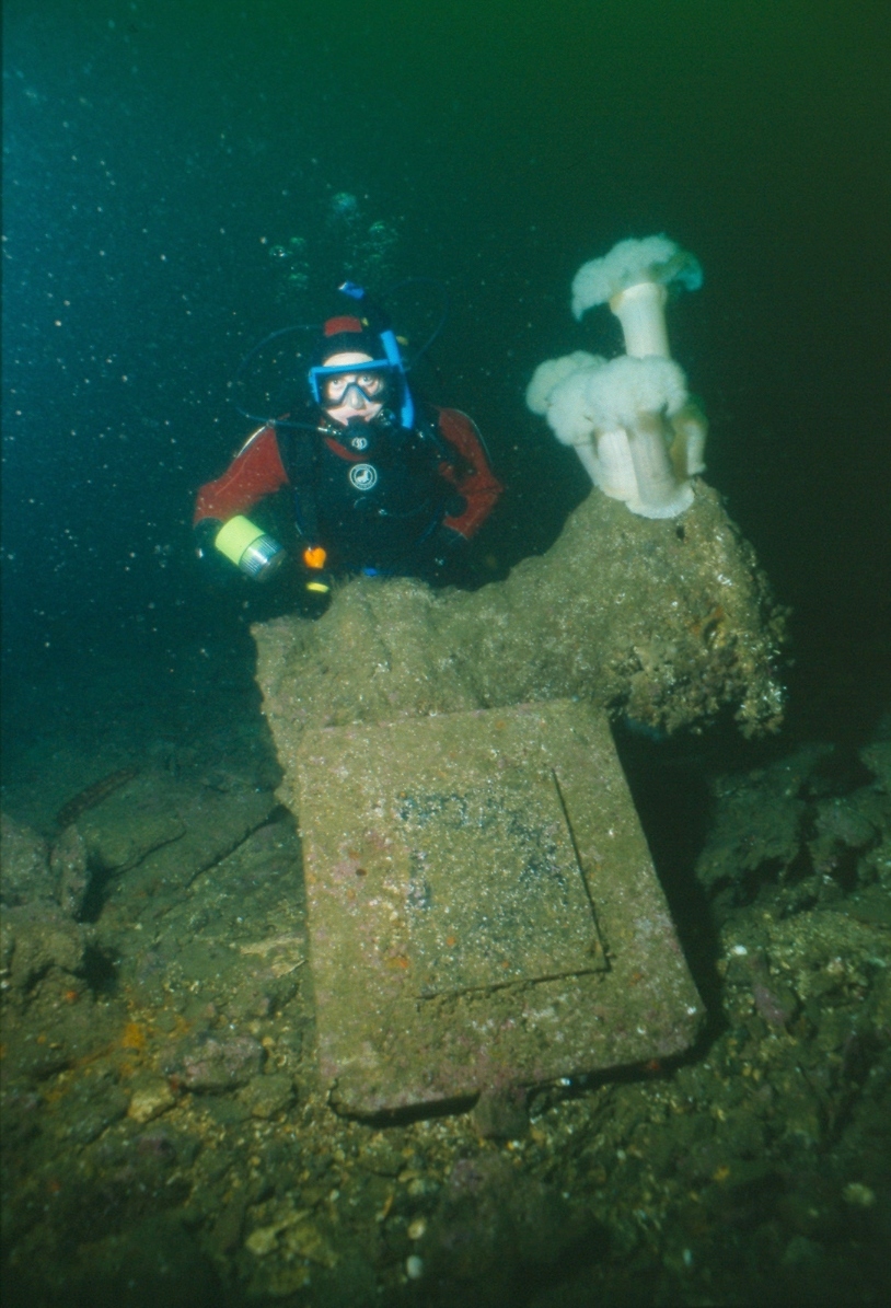 A UASBC diver poses next to the capstan of the Orpheus