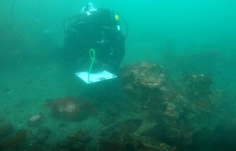 UASBC diver taking notes on the wreck site of the Surprise