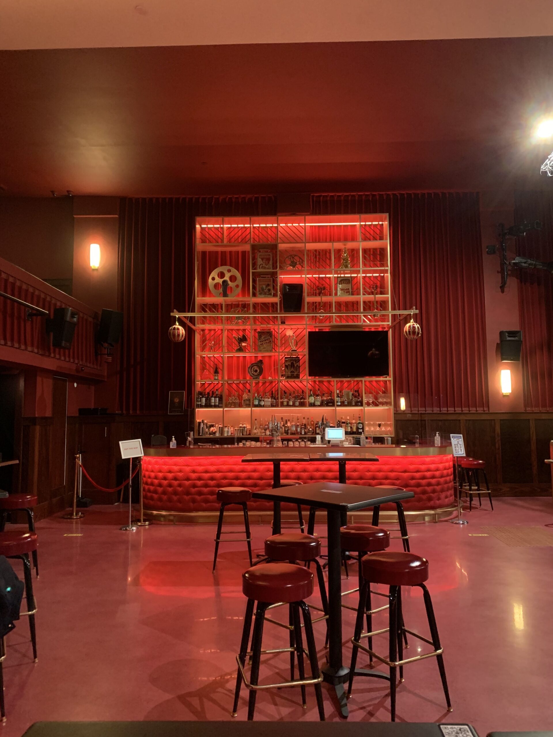 Interior of Hollywood Theatre lit red with view of the bar