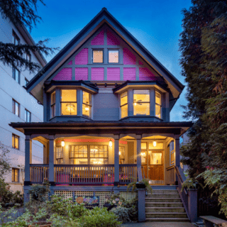 Historic house lit up from the inside.