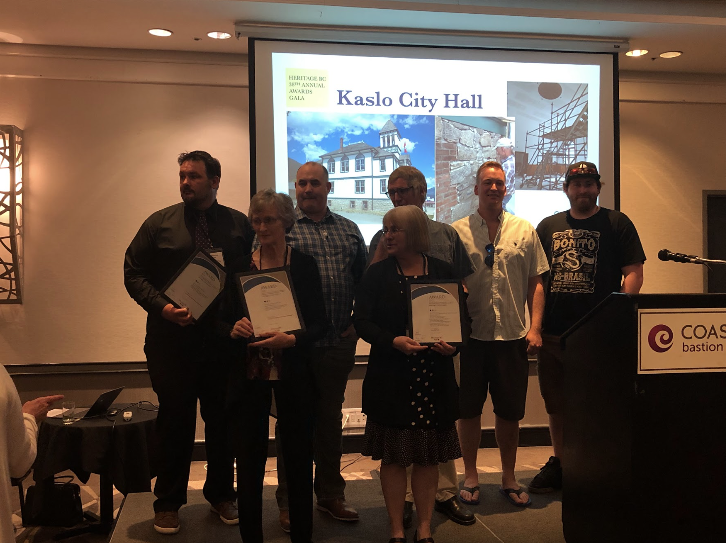Heritage BC award winners at 2019 conference posing with certificates in front of a slideshow
