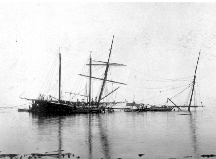 historic photo of half sunk ship with masts above the water