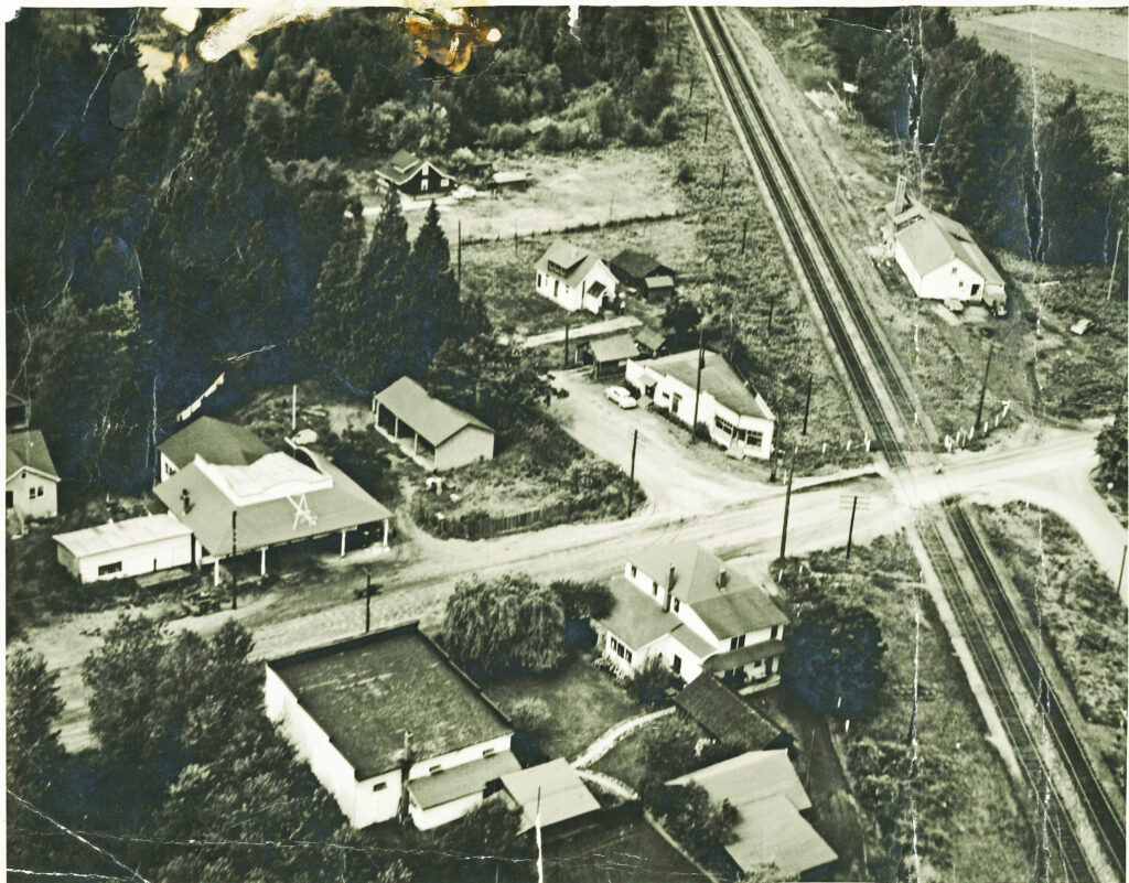 A black and white aerial image of the Hoffmann and Son machine shop just to the south of the CPR crossing on Harris Road, 1955 circa.