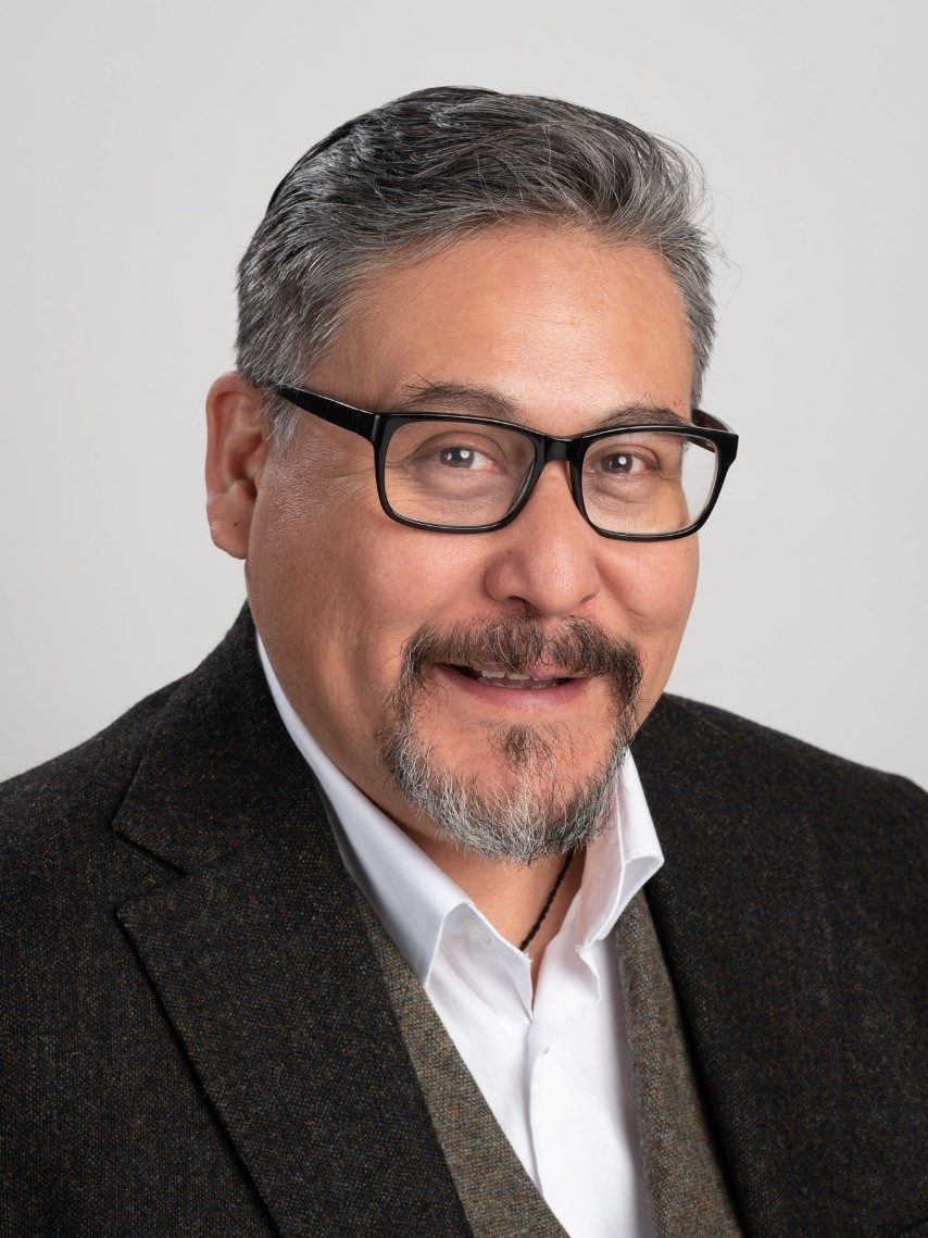 Portrait of a man with glasses on a grey background
