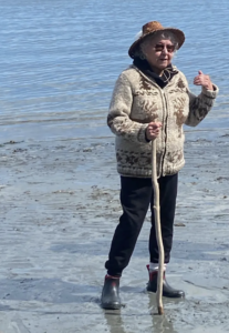 Woman standing on beach with cedar hat